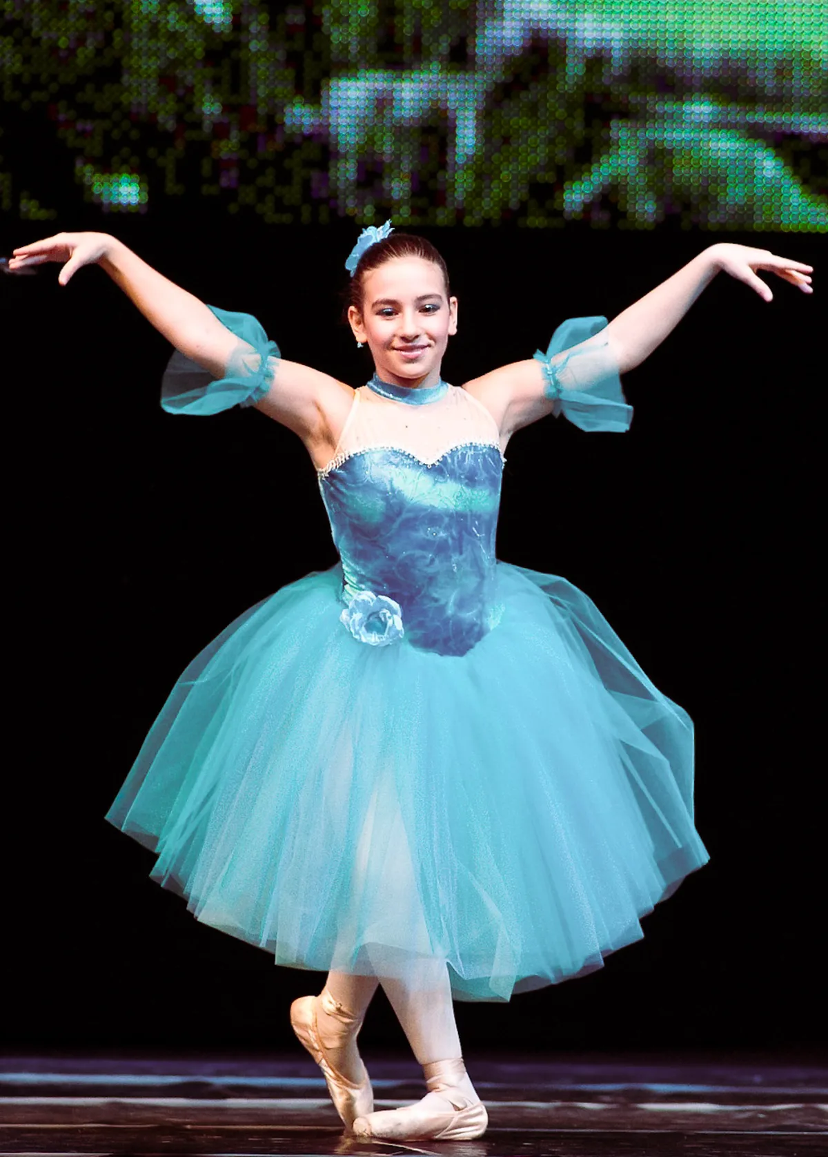 A dancer performing a classical variation on stage